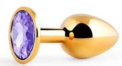 Золотистая анальная пробка с фиолетовым стразом - 7,2 см.